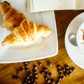 Cappuccino and croissant with coffee bean and books Royalty Free Stock Photo