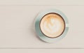 Cappuccino foam, coffee cup top view on white wood background Royalty Free Stock Photo