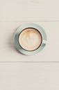 Cappuccino foam, coffee cup top view on white wood background Royalty Free Stock Photo