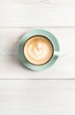 Cappuccino foam, coffee cup top view on white wood background Royalty Free Stock Photo