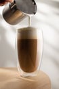 Cappuccino in a glass cup on a wooden table, Coffee and froth milk Royalty Free Stock Photo