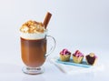 Cappuccino in a glass, Irish glass, cinnamon stick, ground nut and chocolate chips.Tartlets with chocolate paste and hazelnuts, co