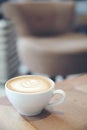 Cappuccino or Latte art coffee made from milk on wooden table in coffee shop