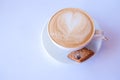 Cappuccino or latte coffee in cup with frothed milk and cookies.Cup of coffee with almond biscotti on white background Royalty Free Stock Photo