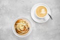 Cappuccino and rolled bun with caramel Royalty Free Stock Photo