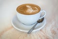Cappuchino or latte coffe in a white cup on a light background Royalty Free Stock Photo