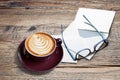 Cappucino with heart shape, letters, enveloppe and eyeglasses Royalty Free Stock Photo