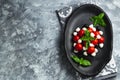 Caprese with cherry tomatoes, mini mozzarella, fresh basil leaves, Traditional italian food, antipasto. banner, menu, recipe place