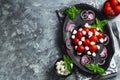 Caprese with cherry tomatoes, mini mozzarella, fresh basil leaves, Traditional italian food, antipasto. banner, menu, recipe place