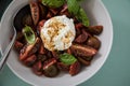 Caprese Mozzarella salad with striped tiger tomatoes in bowl with olive oil, balsamic vinegar and basil on light green background Royalty Free Stock Photo