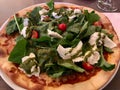 Caprese Pizza with Mozzarella, Arugula, Rucola / Rocket Leaves and Cherry Tomatoes.