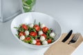 Caprese salad with fresh cherry tomatoes, mini mozzarella, pesto, basil, olive oil and balsamic sauce, with lettuce and arugula Royalty Free Stock Photo