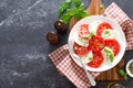 Caprese Salad with fresh tomatoes, basil and mozzarella cheese, top view Royalty Free Stock Photo