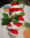 Caprese salad with fresh vine tomatoes and basil Italy chef plate