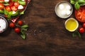 Caprese salad with ripe red tomatoes and mozzarella cheese with fresh green basil leaves. Italian food. Top view, wooden Royalty Free Stock Photo