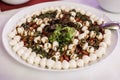 Caprese salad with mozzarella tomato, basil and balsamic vinegar arranged on white plate Royalty Free Stock Photo