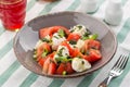 Caprese salad with mozzarella, tomato, basil and balsamic vinegar served on the table Royalty Free Stock Photo