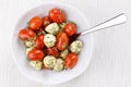 Caprese salad with pesto. Mozzarella cheese and cherry tomatoes with pesto sauce