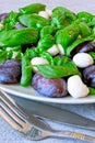 Caprese salad with plums. Fruity caprese. Healthy salad with basil and plums on a plate.