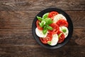 Caprese salad. Salad with mozzarella cheese, fresh tomatoes, basil leaves and olive oil. Italian cuisine Royalty Free Stock Photo