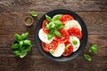 Caprese salad. Salad with mozzarella cheese, fresh tomatoes, basil leaves and olive oil. Italian cuisine Royalty Free Stock Photo