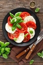 Caprese salad. Salad with mozzarella cheese, fresh tomatoes, basil leaves and olive oil. Italian cuisine Royalty Free Stock Photo