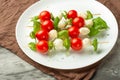 Caprese salad - shish kebab with tomato, mozzarella and basil, Italian cuisine and healthy vegetarian diet on a dark background fr Royalty Free Stock Photo