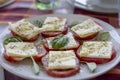 Caprese salad, slices of tomato, cheese of mozzarella ann spices, typical mediterranean meal