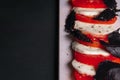 Caprese salad with tomatoes, basil and mozzarella. Top view and flat lay Royalty Free Stock Photo