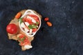 Caprese and Toast bruschetta with mozzarella cheese, cherry tomatoes and fresh garden basil. Traditional Italian food, healthy Royalty Free Stock Photo