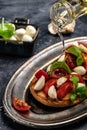 Caprese toasts with mozzarella, cherry tomatoes and fresh garden basil. Traditional italian appetizer or snack, antipasto. top Royalty Free Stock Photo