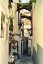 CAPRI, ITALY, 1978 _ A characteristic street with arches of Capri awaits tourists with its shops