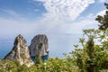 Capri Italy, island in a beautiful summer day, with faraglioni rocks and natural stone arch. Royalty Free Stock Photo