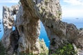 Capri Italy, island in a beautiful summer day, with faraglioni rocks and natural stone arch. Royalty Free Stock Photo