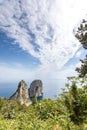 Capri Italy, island in a beautiful summer day, with faraglioni rocks and natural stone arch. Royalty Free Stock Photo