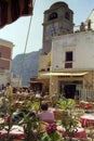 CAPRI, ITALY, 1984 - The pink color dominates among the tables of the bars of the famous Piazzetta di Capri