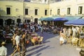 CAPRI, ITALY, 1965 - The sun sets on the coffee tables and on passers-by in the famous Piazzetta of Capri
