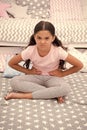 Capricious mood. Girl child sit in bedroom. Kid unhappy capricious someone entered her bedroom bothering . Girl kid long Royalty Free Stock Photo