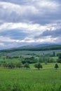 Capricious spring with dramatic cloudy sky above grasslands and hills in the Rhine valley