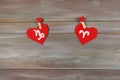Capricorn and Aries. signs of the zodiac and heart. wooden backg