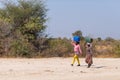 Caprivi, Namibia - August 20, 2016: Poor women walking on the roadside in the rural Caprivi Strip, the most populated region in Na