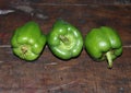 Capsicum, three capsicum on the wooden table. capsicum other name is chili pepper or bell pepper vegetable fruits.