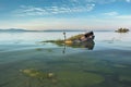 capsized boat in shallow water, sandbar visible Royalty Free Stock Photo