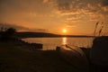 Capsized boat on the shore of Razelm Lake, in sunset Royalty Free Stock Photo