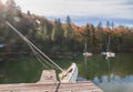 Capsized sailboat near the pier on Lake Bohinj. Autumn landscape in Slovenia Royalty Free Stock Photo