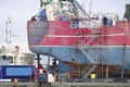 Capsized ship vessel and rescue lift crane at port dock for repair of shipwreck Royalty Free Stock Photo