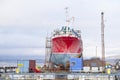 Capsized ship vessel and rescue lift crane at port dock for repair of shipwreck Royalty Free Stock Photo