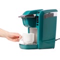 Capsular electric coffee machine cup in hand Royalty Free Stock Photo