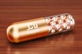 Capsule with copper Cu element on the wooden table. 3D rendering