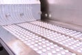 Capsule medicine pill production line, Industrial pharmaceutical concept. Tablets coming out of the machine. Pharmacy Royalty Free Stock Photo